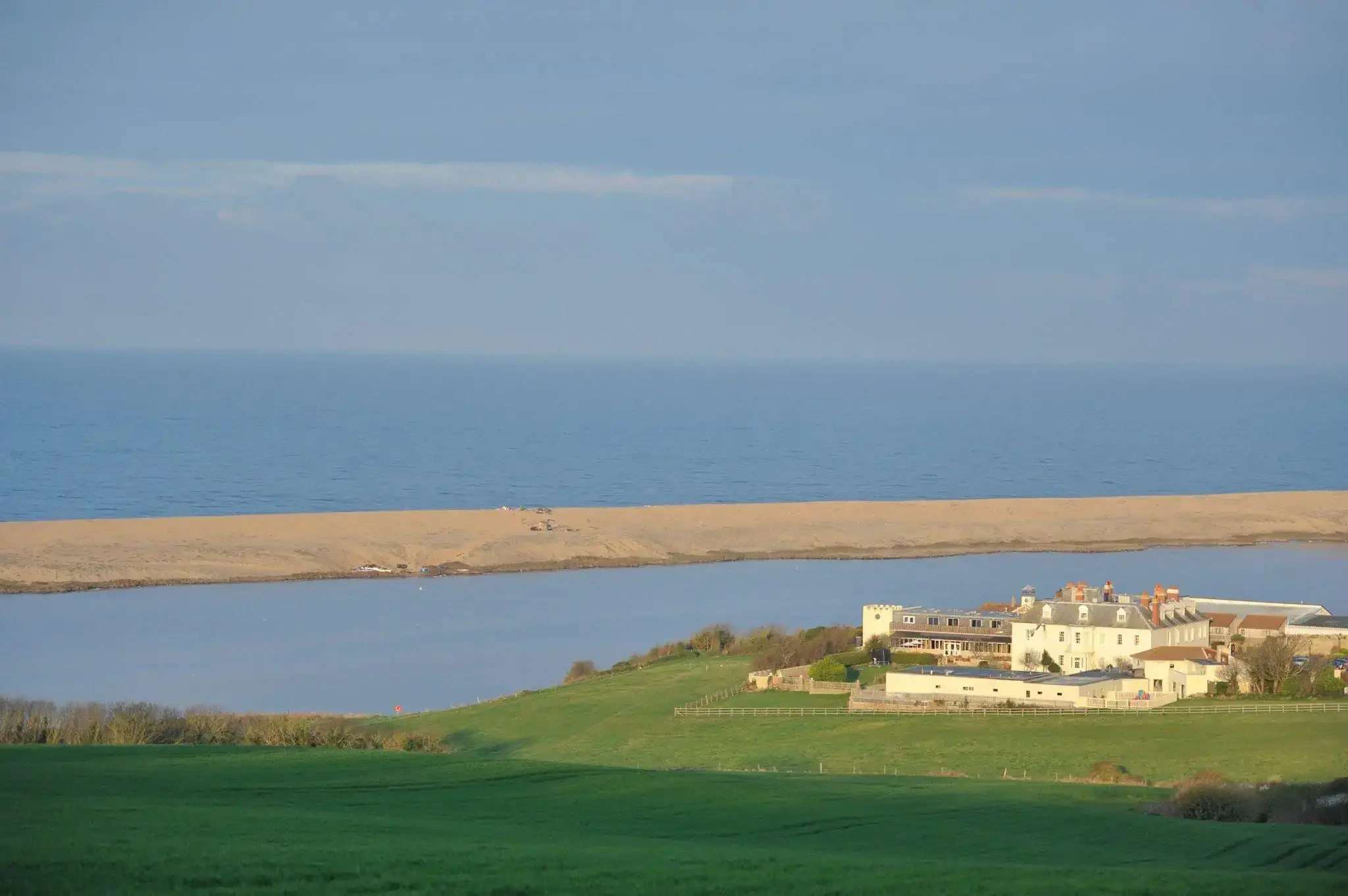 Aerial view of moors and a manor by the sea