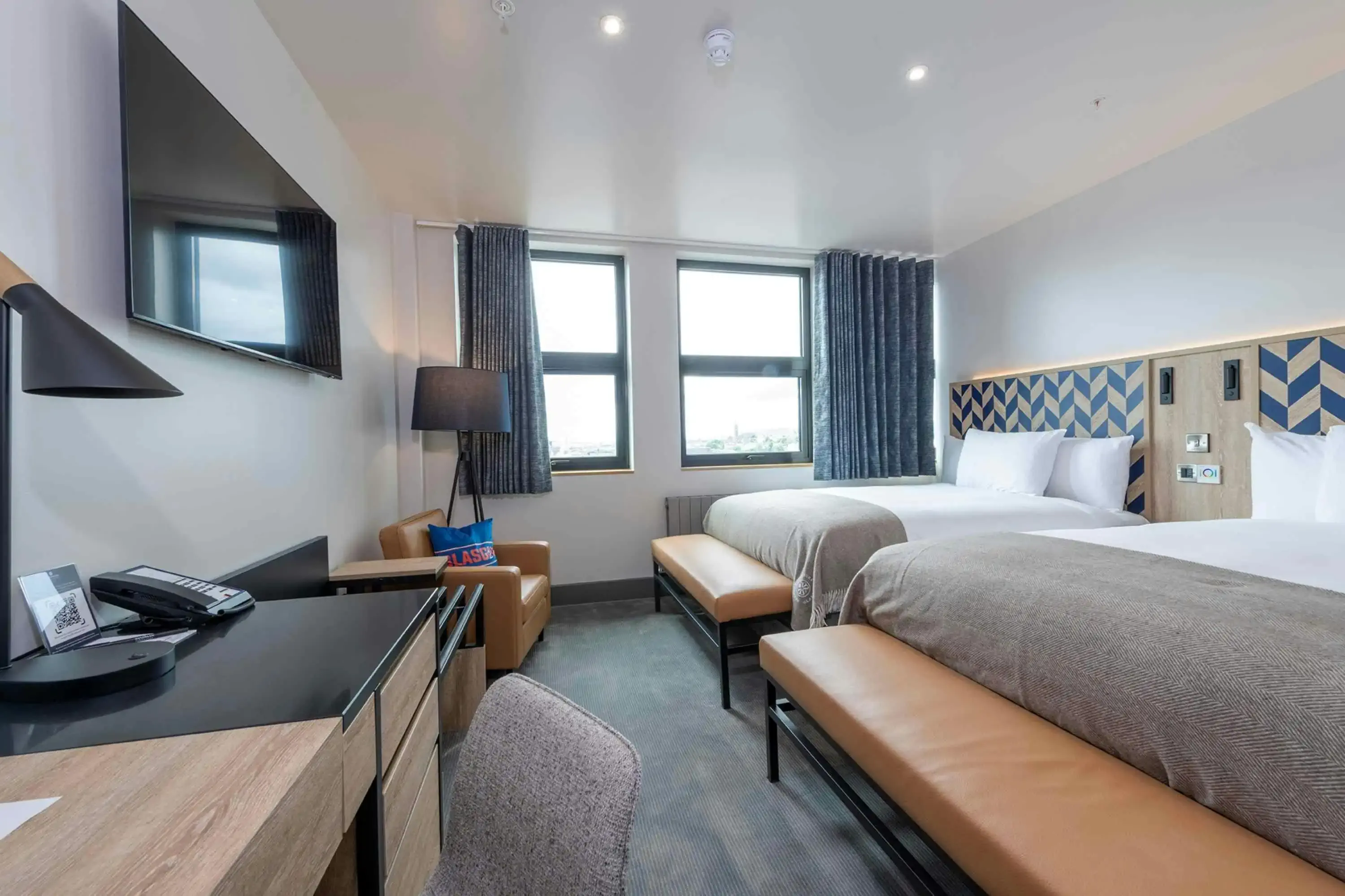 Modern hotel room with two large beds