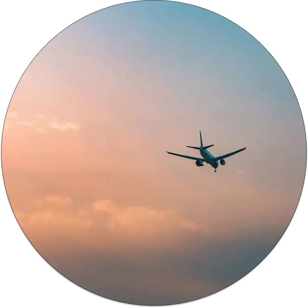 A plane flying over pink night sky