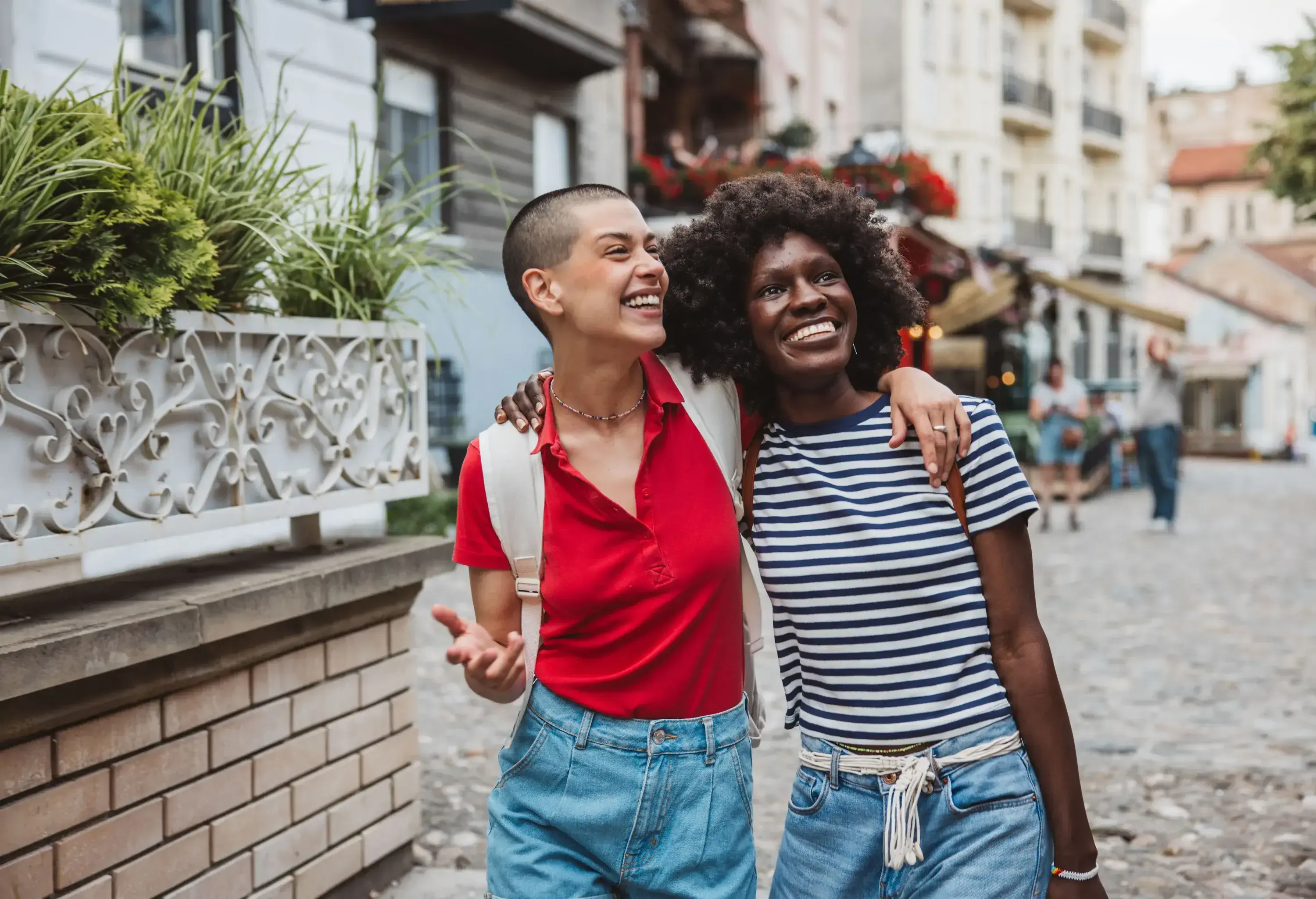 Young lesbian couple traveling and exploring city on vacation.