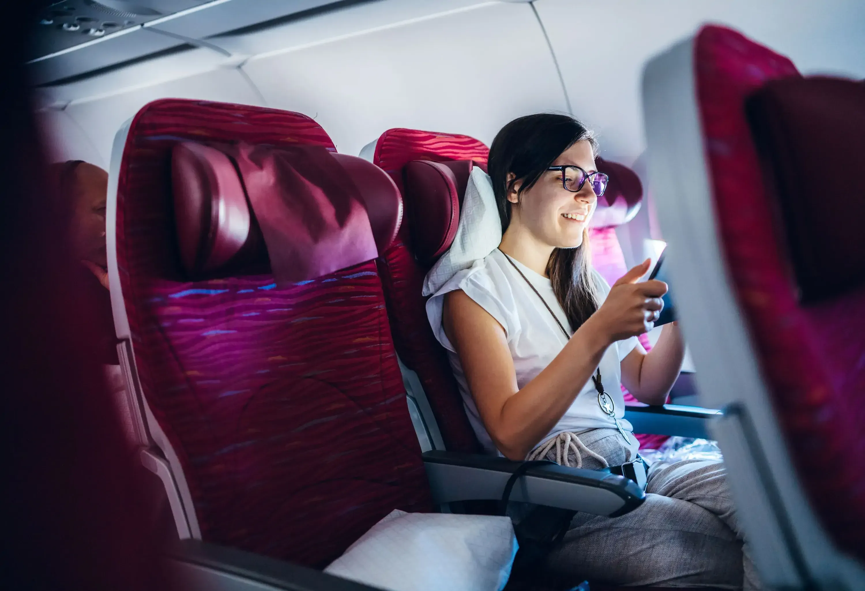 Caucasian woman using digital tablet on an airplane in premium economy