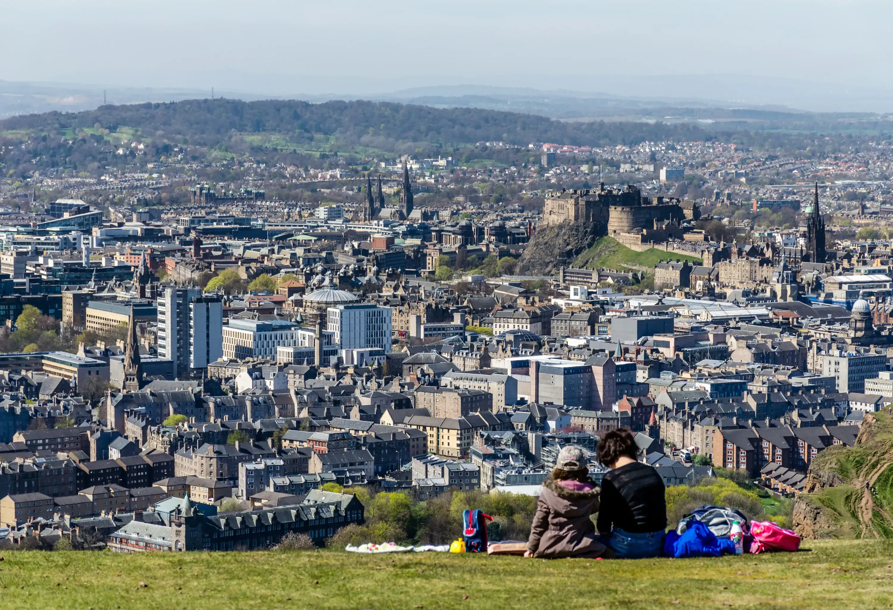 A mother and daughter enjoy a picnic atop of Arthur's Seat in Holyrood Park, Edinburgh. Arthur's Seat is the highest point in Edinburgh and offers spectacular views over the City including the Old Town and Castle.
