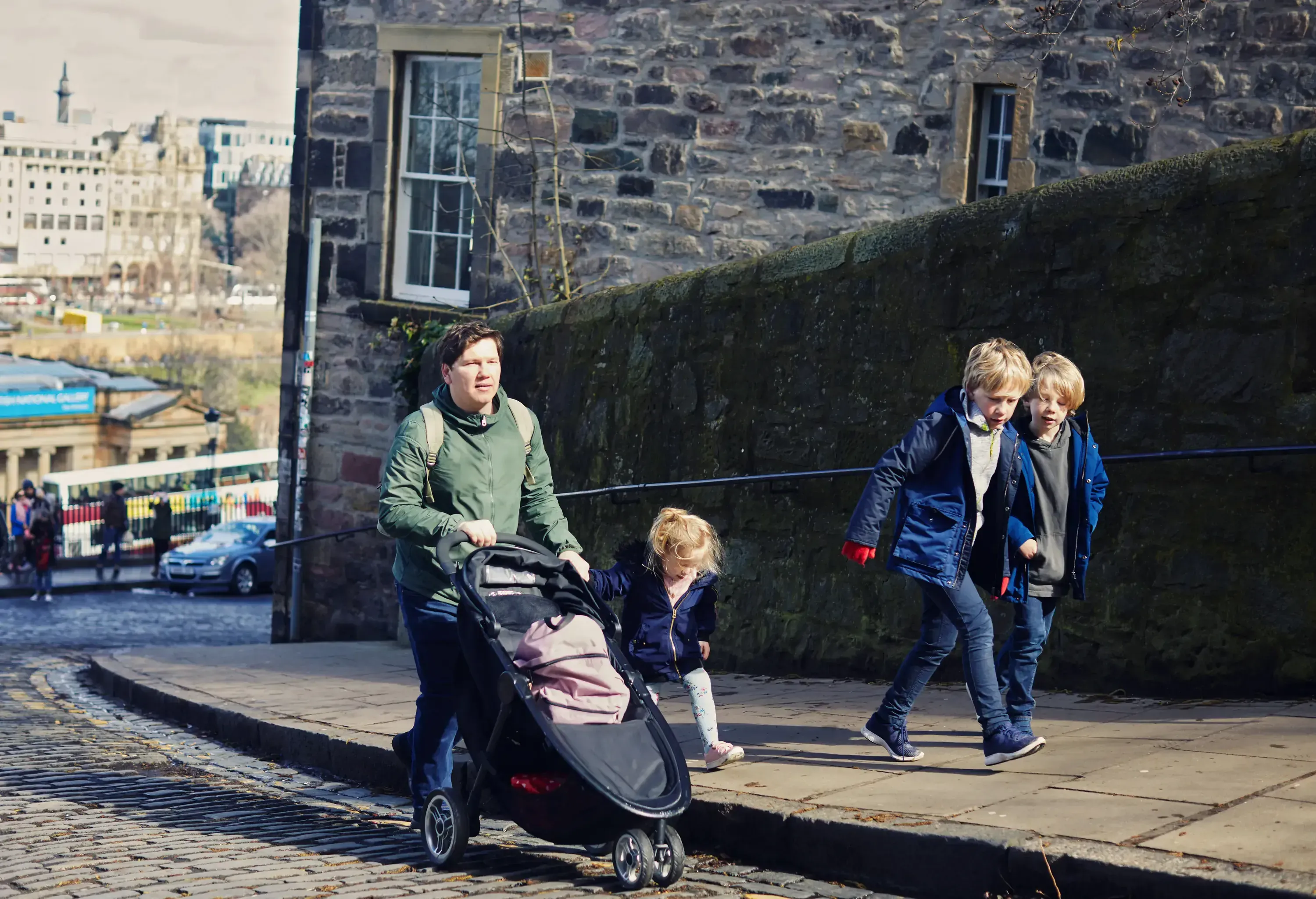 Father and two sons and daughter walking in Edinburgh together