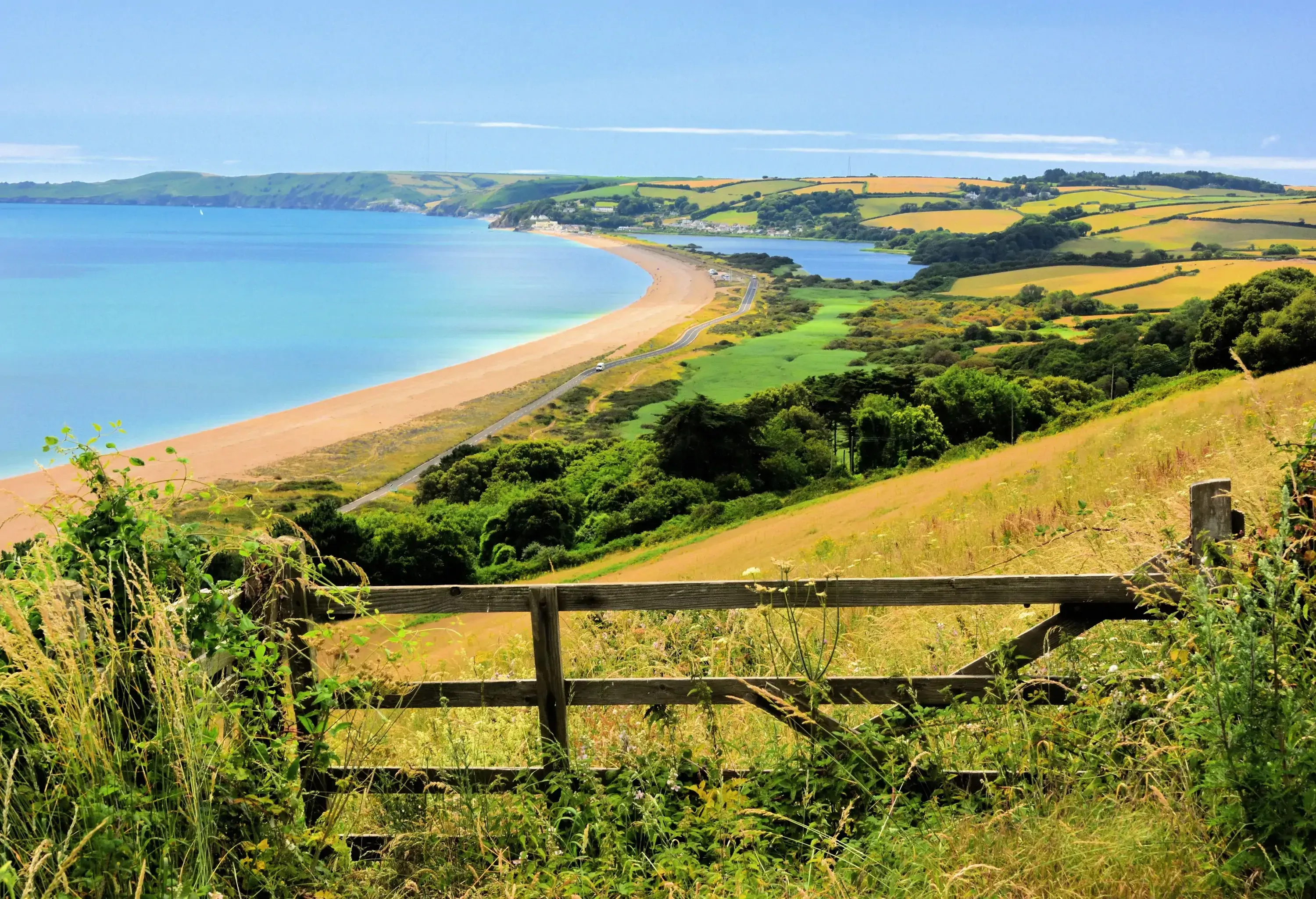 Slopes of greenery leading down into the sea that stretch off into the horizon.