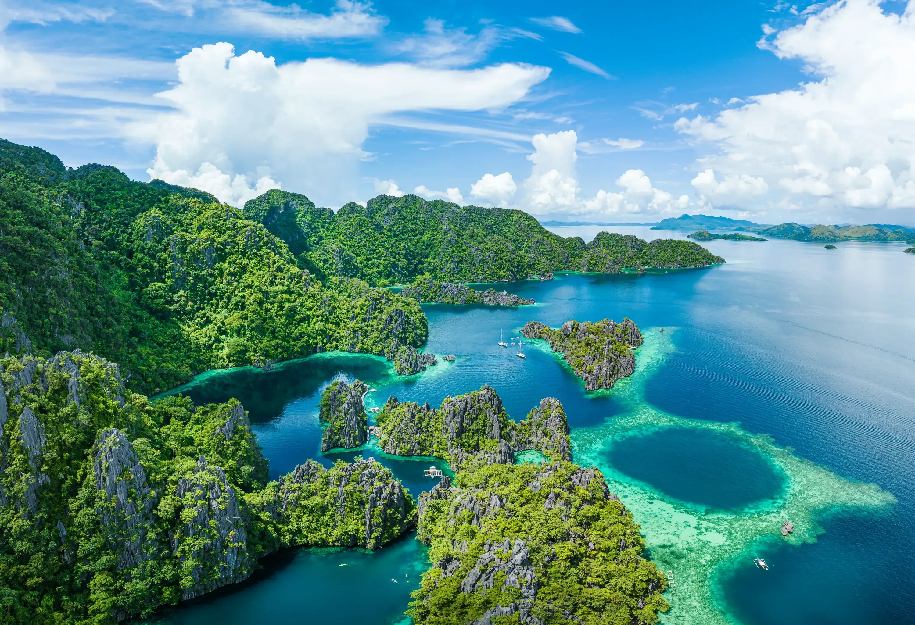 Beautiful Island Beach Lagoon with typical filipino Balangay Boats. Aerial Drone Point of View. Palawan, Philippines, Asia