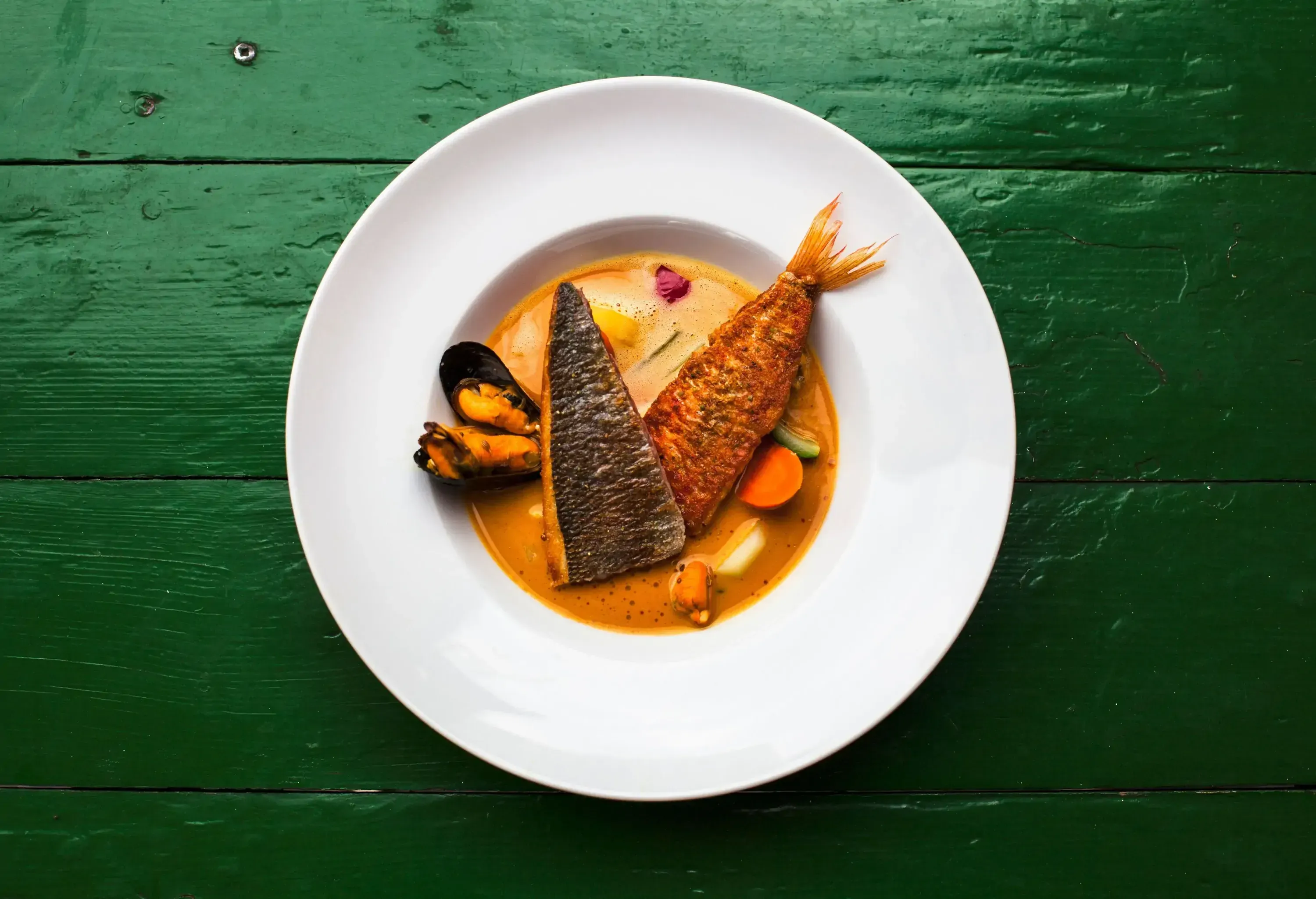 A creamy fish stew with shell fish and vegetables.