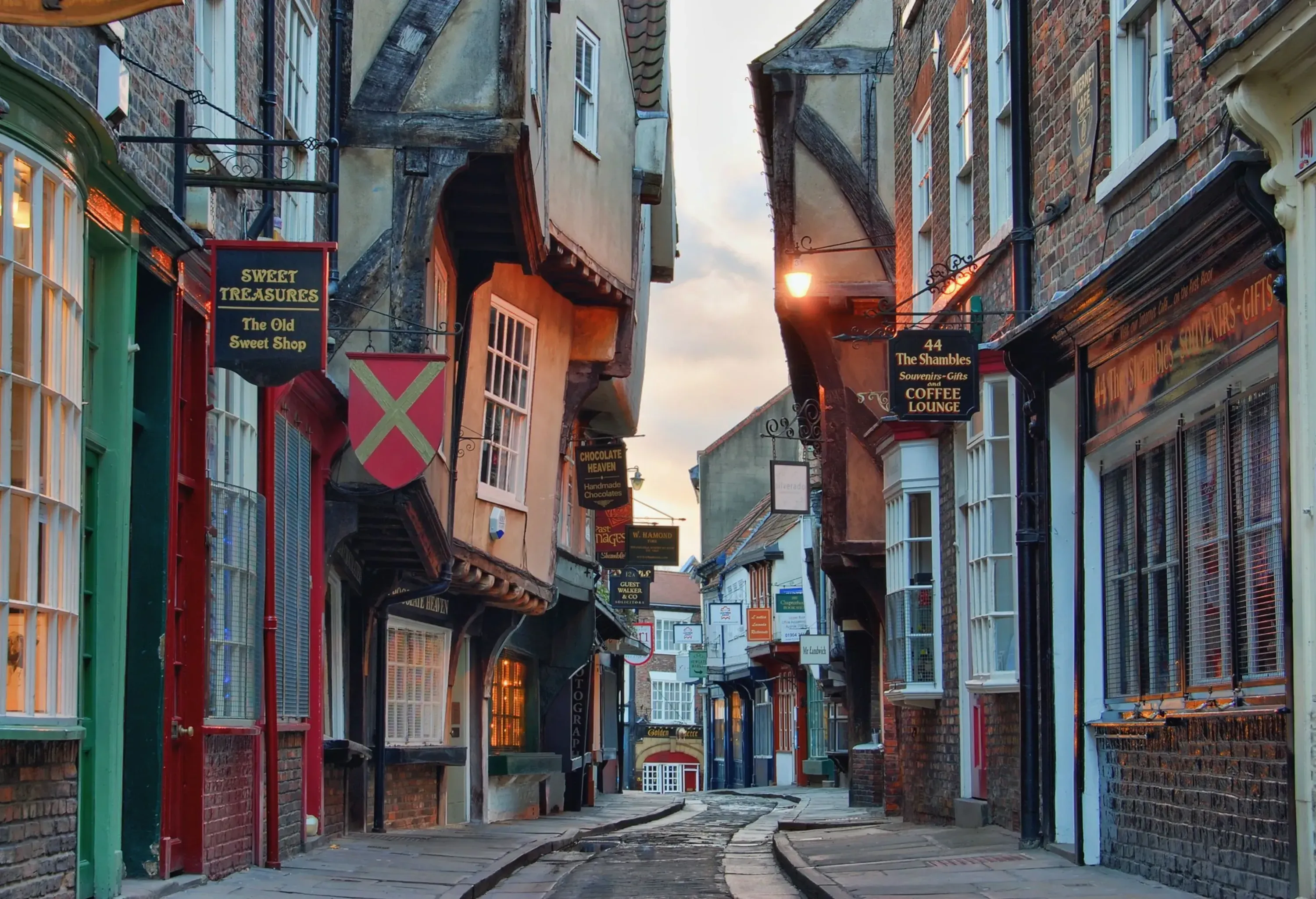 A neighbourhood street bordered with shops and cafés.